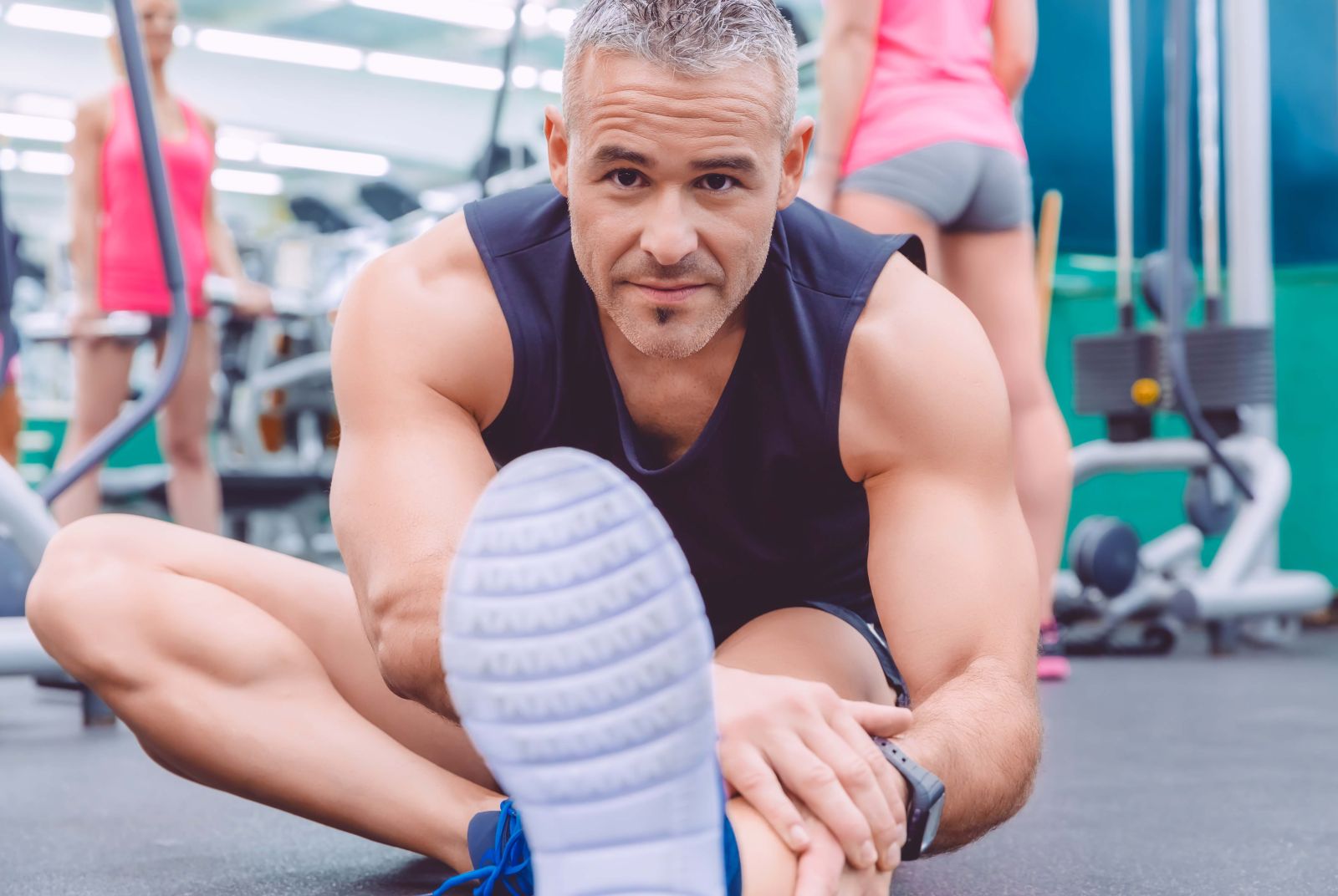 Man stretching and woman doing dumbbells exercises 2023 11 27 05 10 22 utc