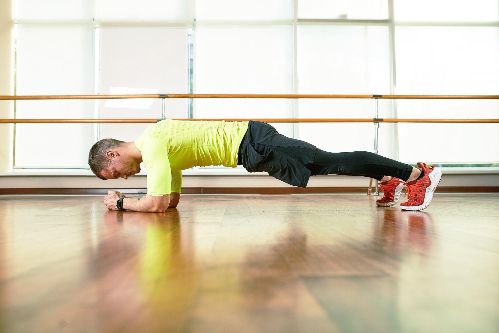 A man does an exercise plank in the hall on the fl 2024 03 05 11 23 13 utc