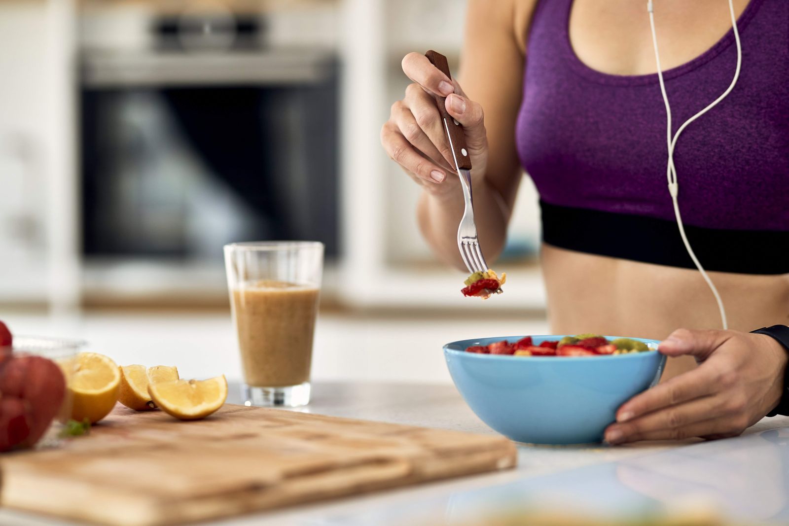 Close up of athletic woman eating fruit salad in t 2023 11 27 05 23 27 utc